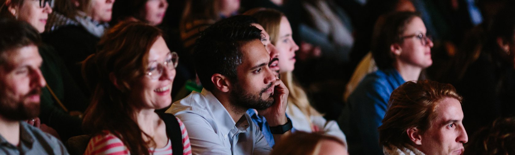 Audience members in indoor theatre