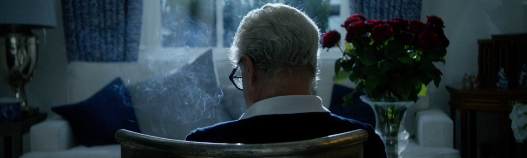 Back of man in chair surrounded by smoke