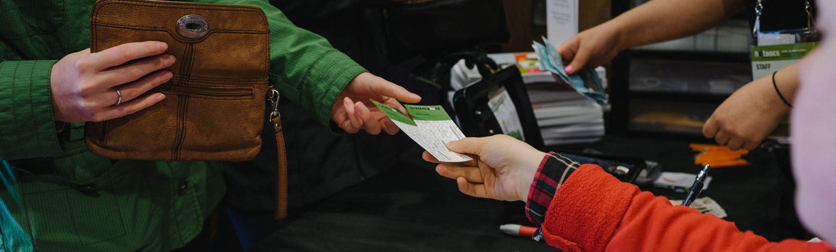 Woman being given ticket at box office