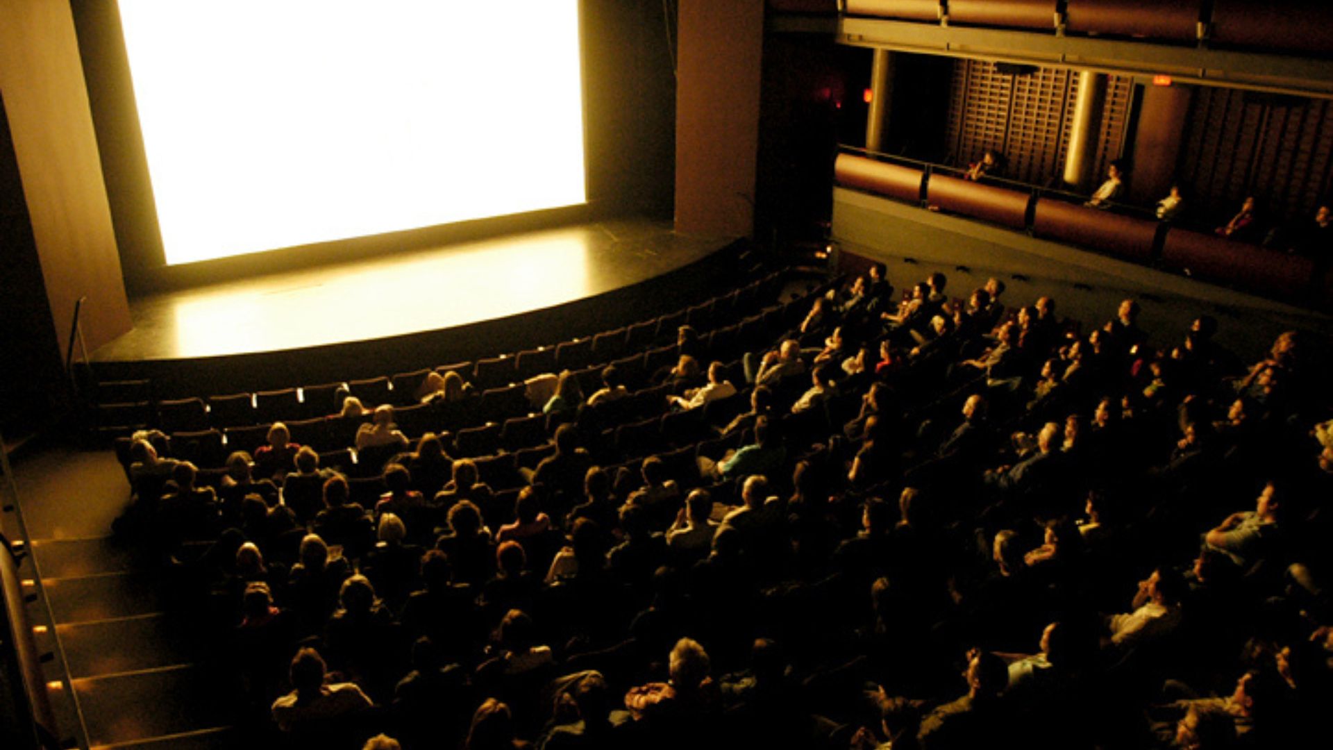 Black and white indoor cinema audience and screen